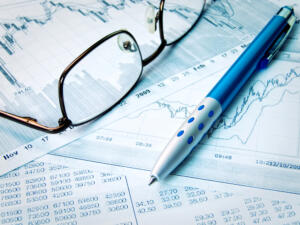 pen and glasses on closing cost documents