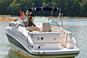 rear view of a white boat in the water with man and woman aboard