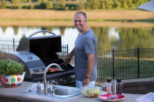 grilling burgers by the lake