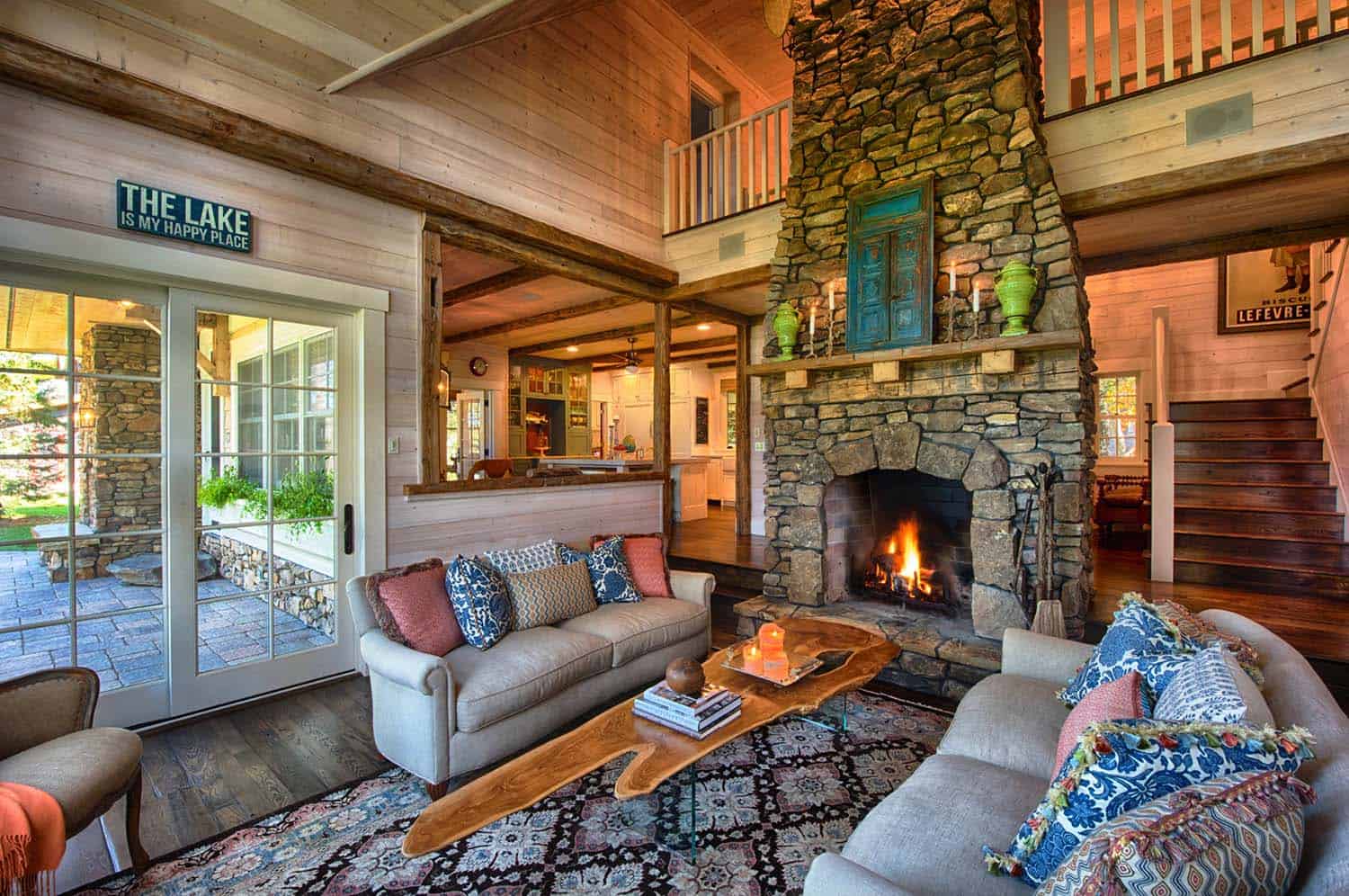Lake home living room with burning fireplace | Lake Homes Realty
