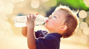toddler drinking from a water bottle 