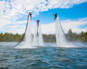 three men jet packing out of the water 