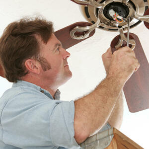 man installing ceiling fan