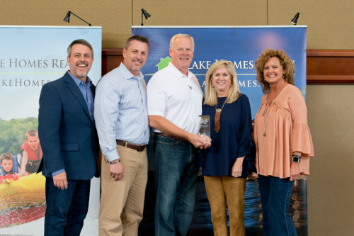 Lake Homes Realty CEO, COO and Splash Award Winners holding award plaque