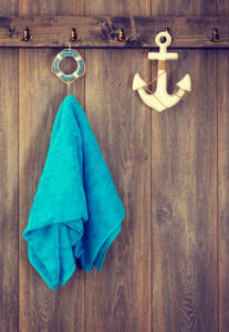 nautical style: blue towel hanging next to a decorative anchor