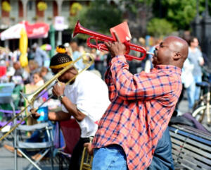 man in Louisiana playing a red trumpet