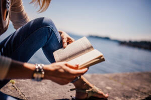 girl reading at lake