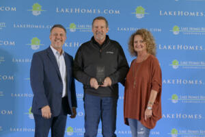 Lake Homes Realty CEO Glenn S. Phillips and COO Doris Phillips with Bruce Jones
