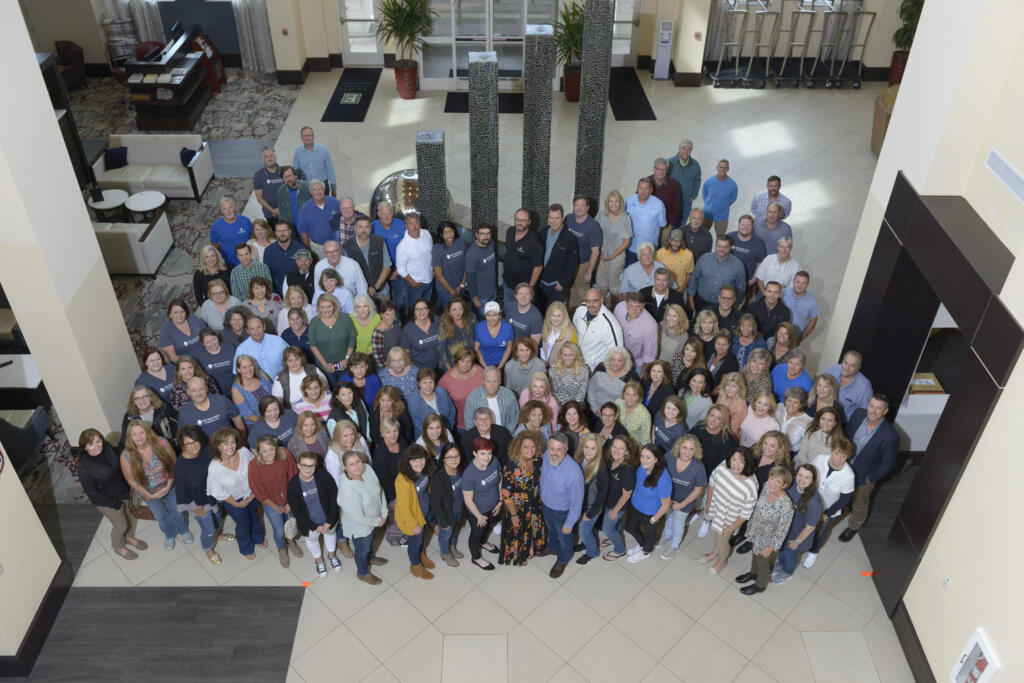 Lake Homes Realty agents and staff pose for a group photo during the Summit.