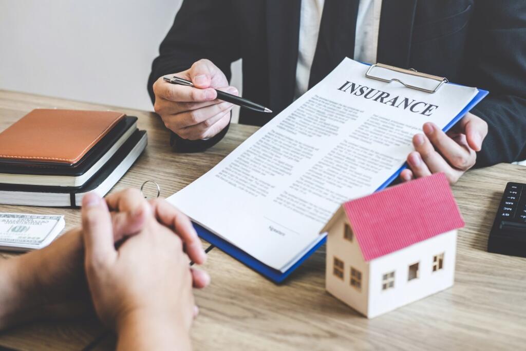 Person holding clipboard with insurance contract