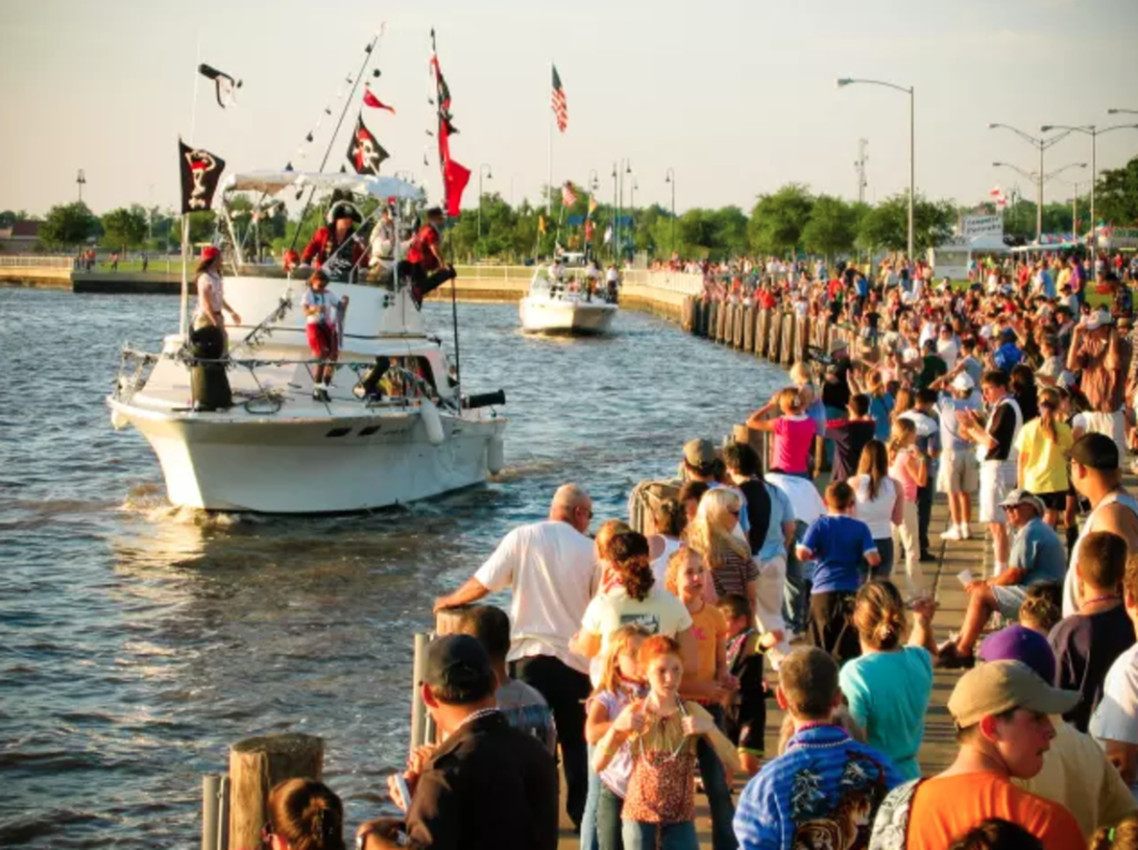 Lake Charles Pirate Festival boat on water with crowd