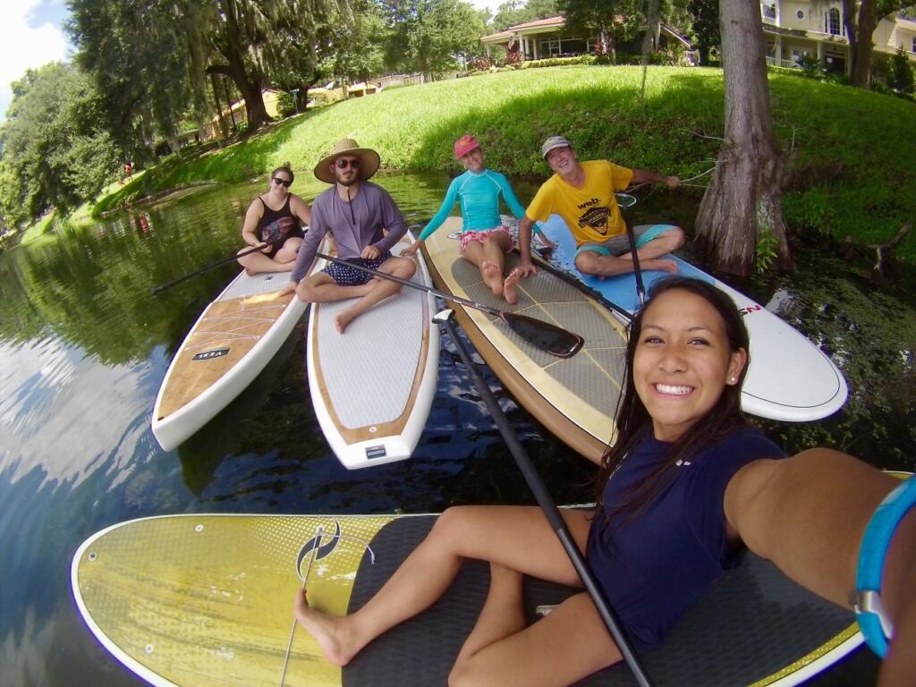 Community of lake homeowners paddleboarding together