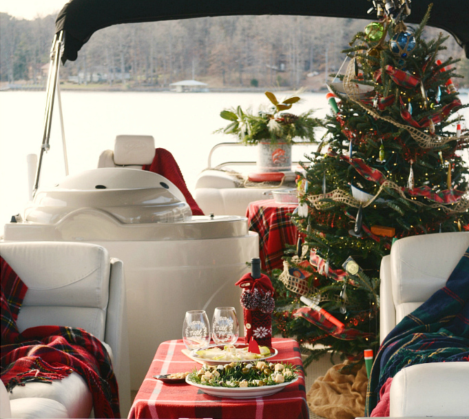 Decorated Christmas tree on boat on lake winter tradition