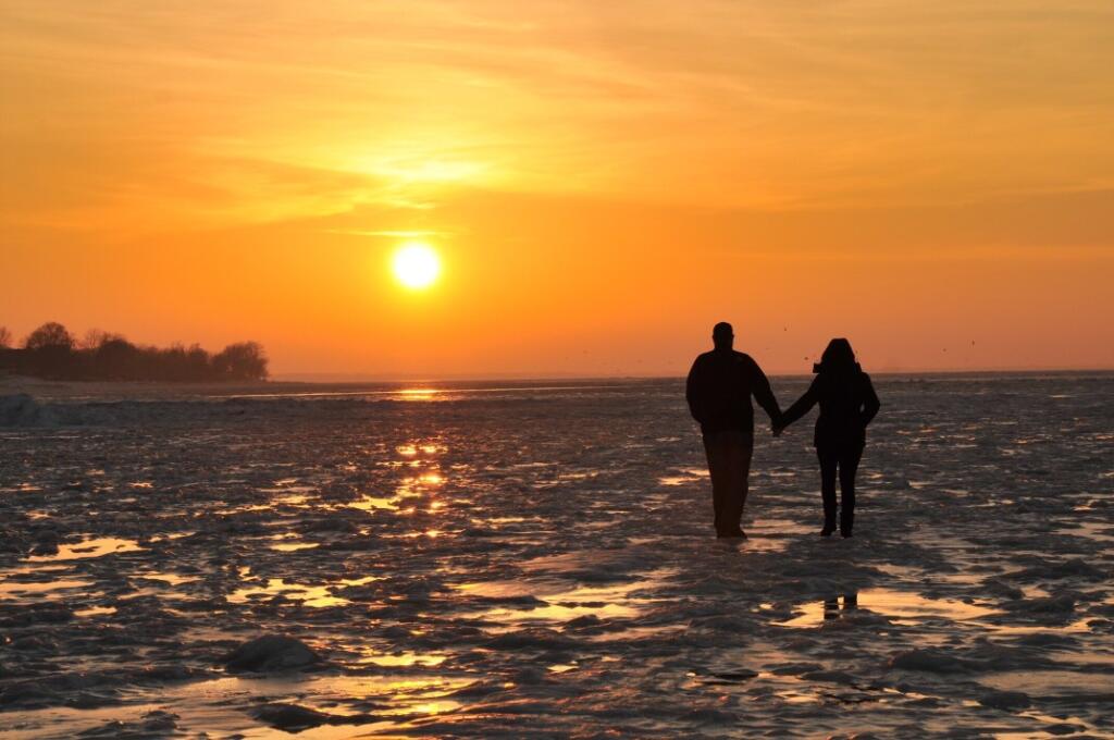 Couple holding hands morning fitness exercise at the lake