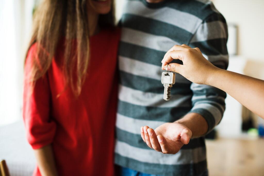 Homeowners being handed keys owning a lake home