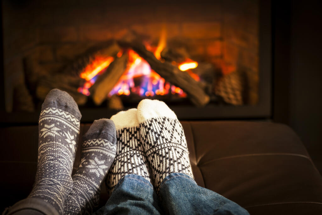two people in front of fireplace
