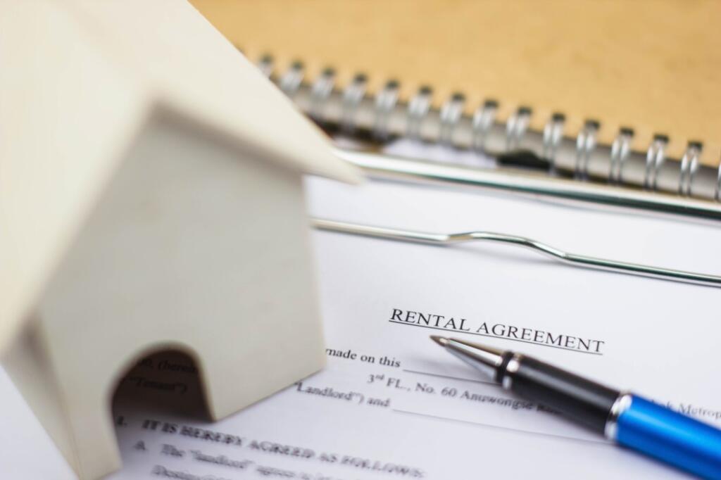 rental agreement paper with pen and house