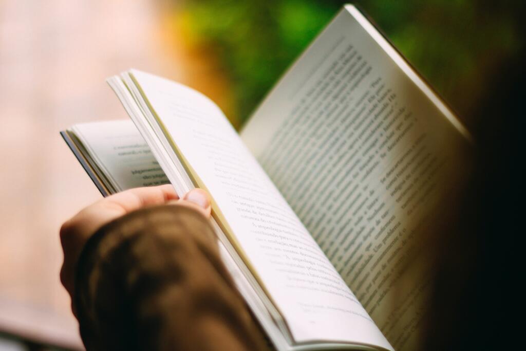 Person reading a book during winter