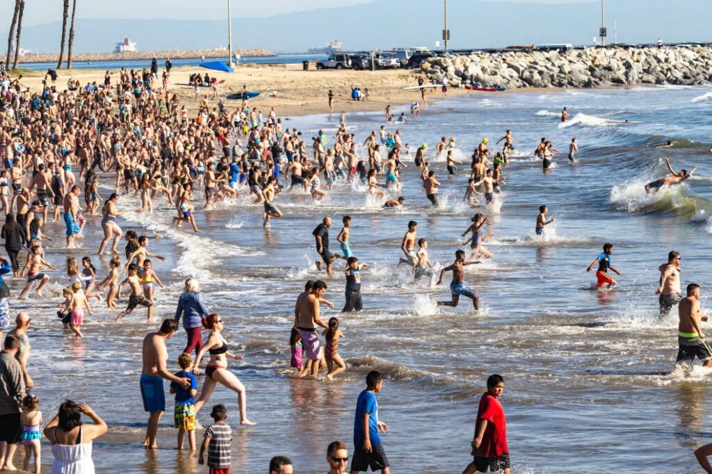 participants running into San Pedro beach on new year's day