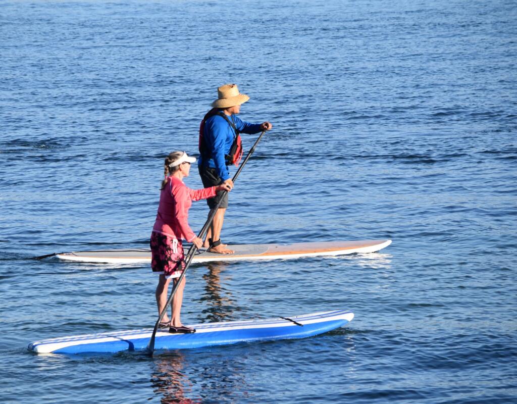 Retirees paddle boarding