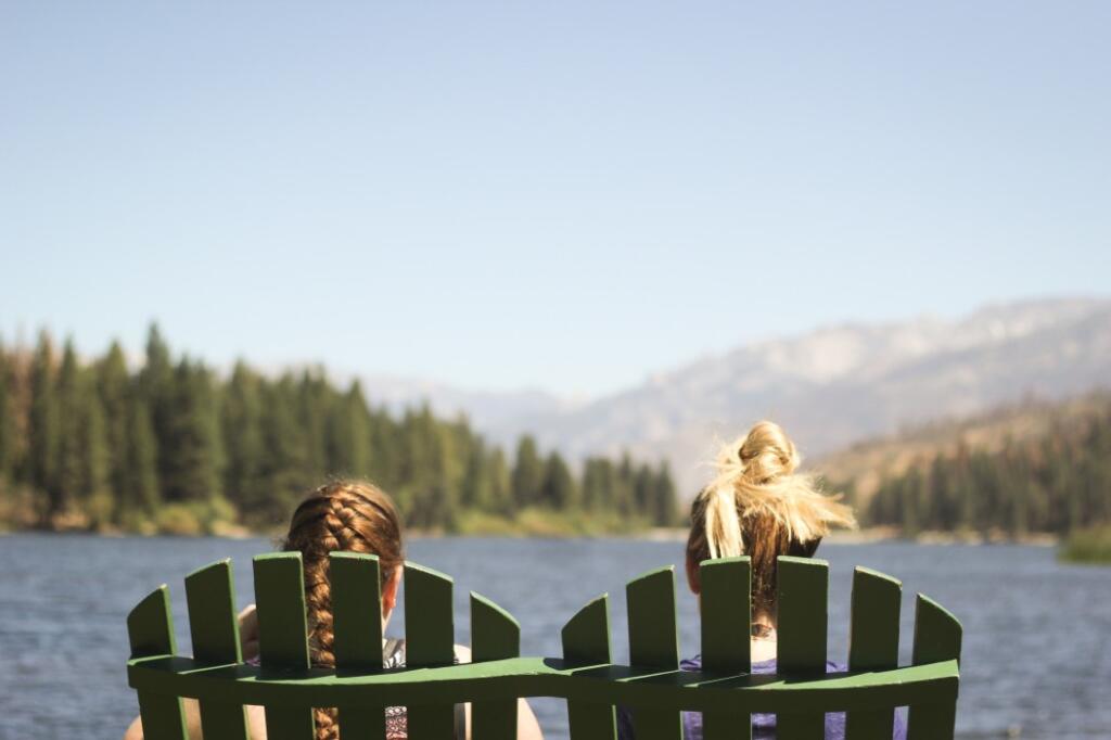 Two people sitting in Adirondack chairs