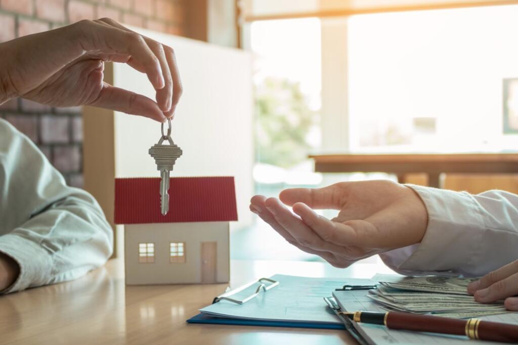 person handing keys over for rental agreement