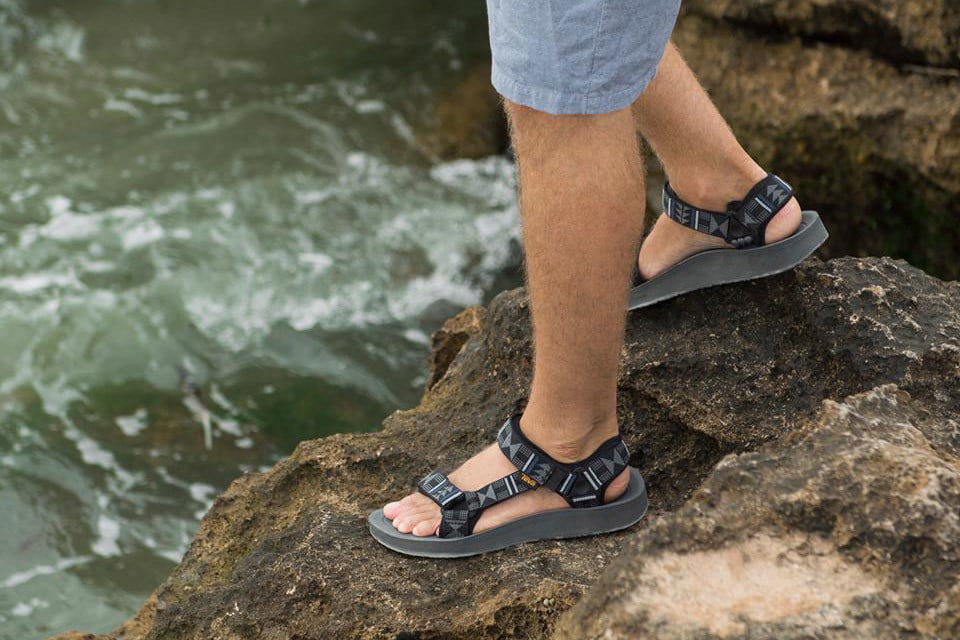 Teva sandals person walking at lake best shoes for water