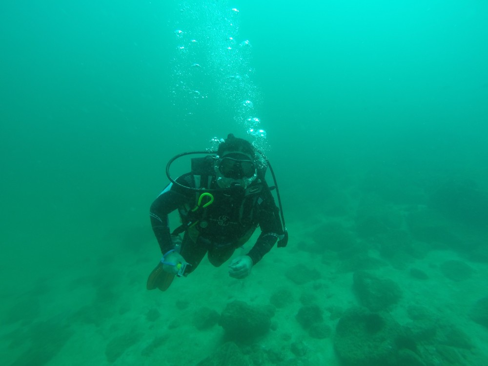 person scuba diving at lake keowee