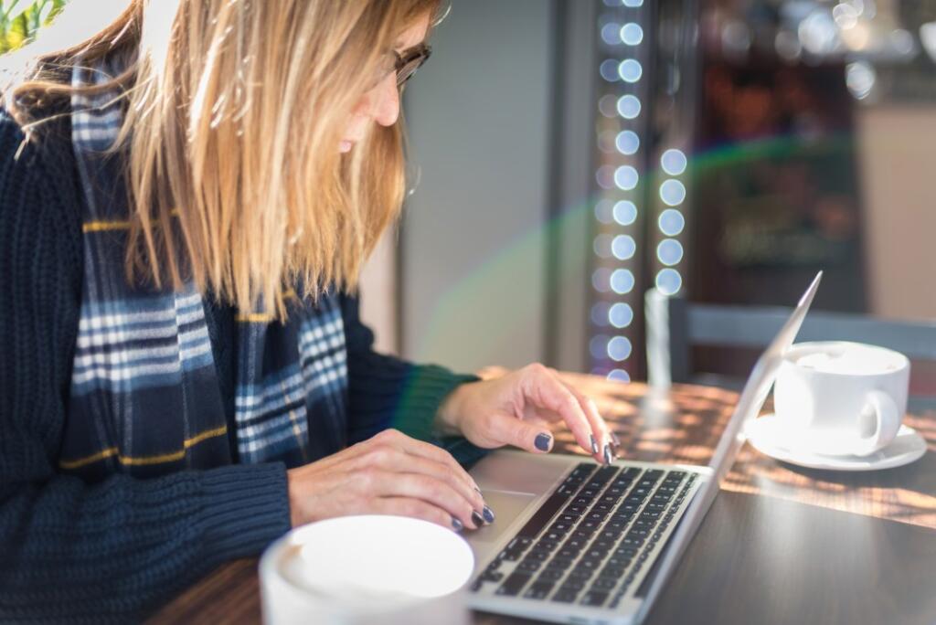 Woman using laptop to look up real estate