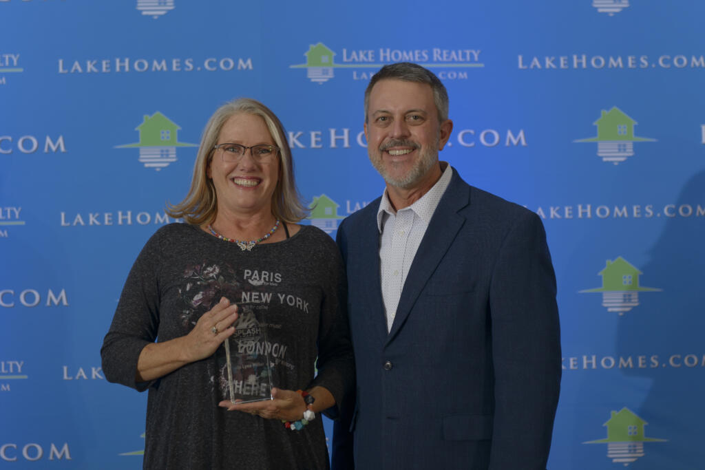 Jo Lynn Miller, Splash Award winner and Agent of the Year with Glenn S. Phillips, Lake Homes Realty's CEO.
