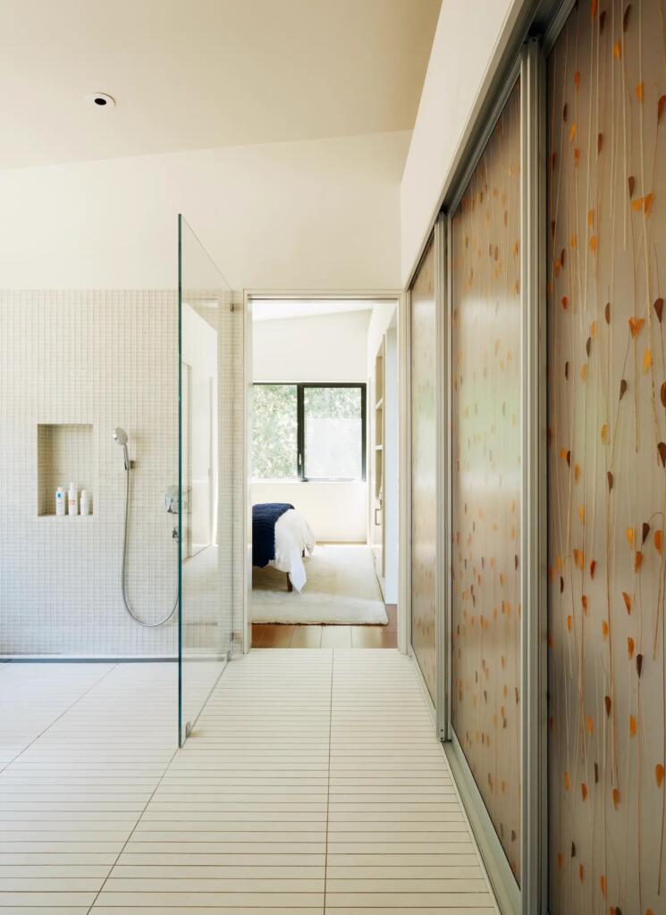 zero-step entrance into shower with lowered shower head and lowered built-in storage shelf