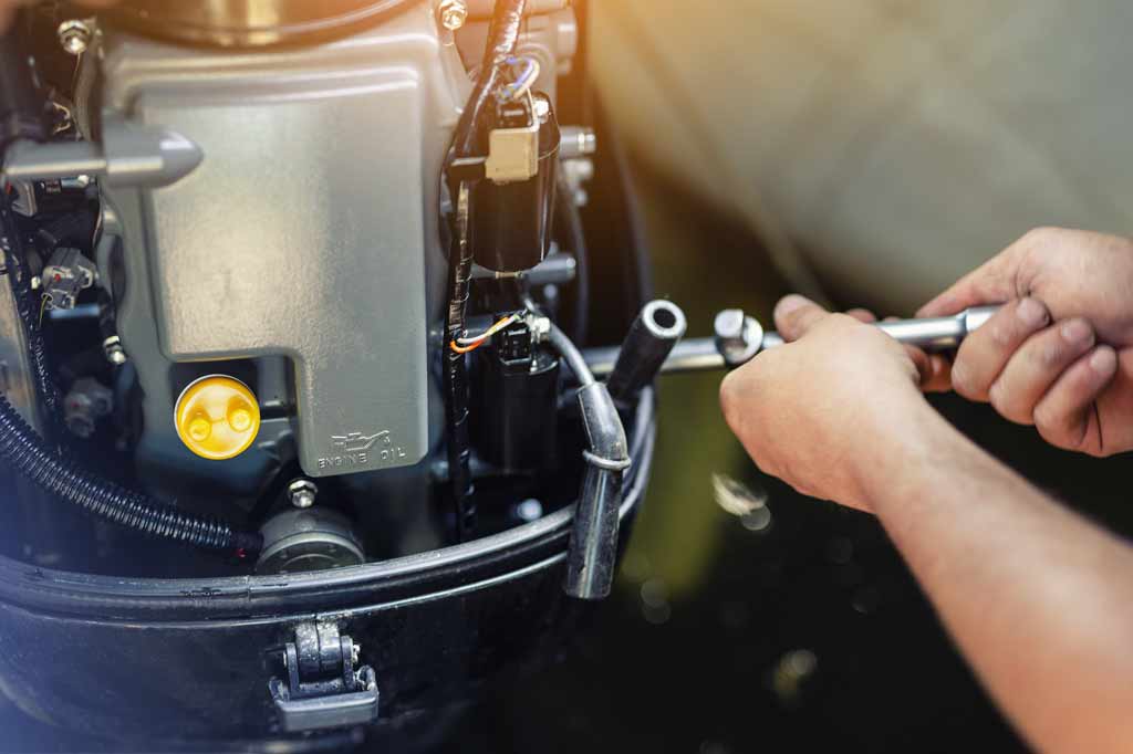 person working on a boat engine