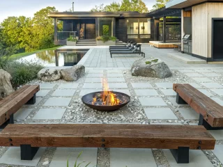 patio with stone pavers, rocks, gravel, fire pit, and pool