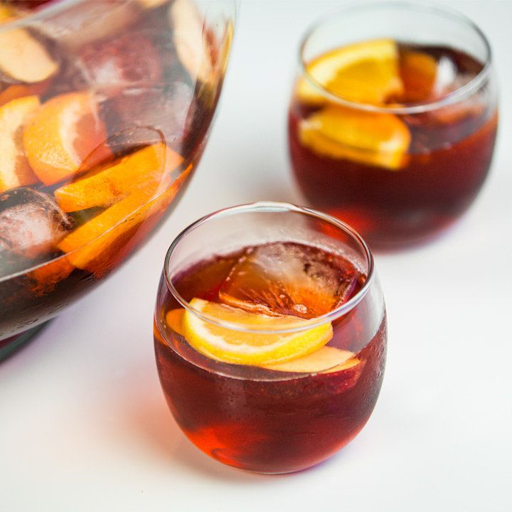 Negroni Sbagliato punch service in glasses with orange slices and ice cubes