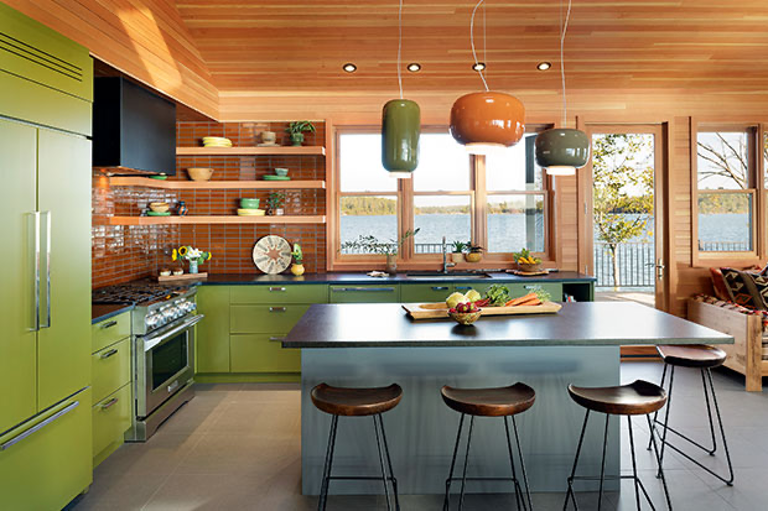 Nature-inspired color palette in lakefront kitchen with natural woods, bright greens, and rich orange hues with lake in the background