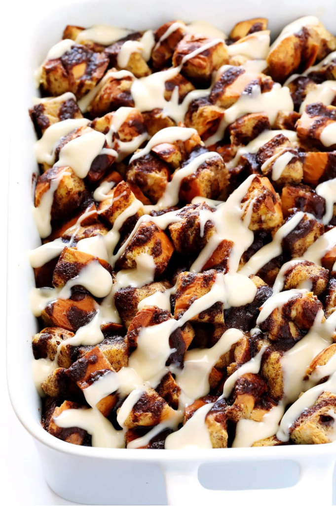 Overnight Cinnamon Roll Casserole made with Challah bread and drizzled with cream cheese icing in a baking dish