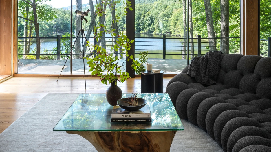 Earthy, water-inspired interior palette in living room of lake home with natural materials, reflective surfaces, neutral tones and textures that mirror the natural surroundings.